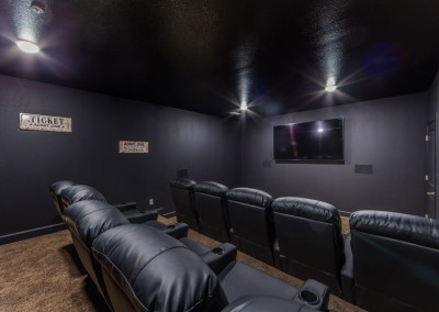 Villages at Ben White theater room with a large television and leather movie theater style chairs